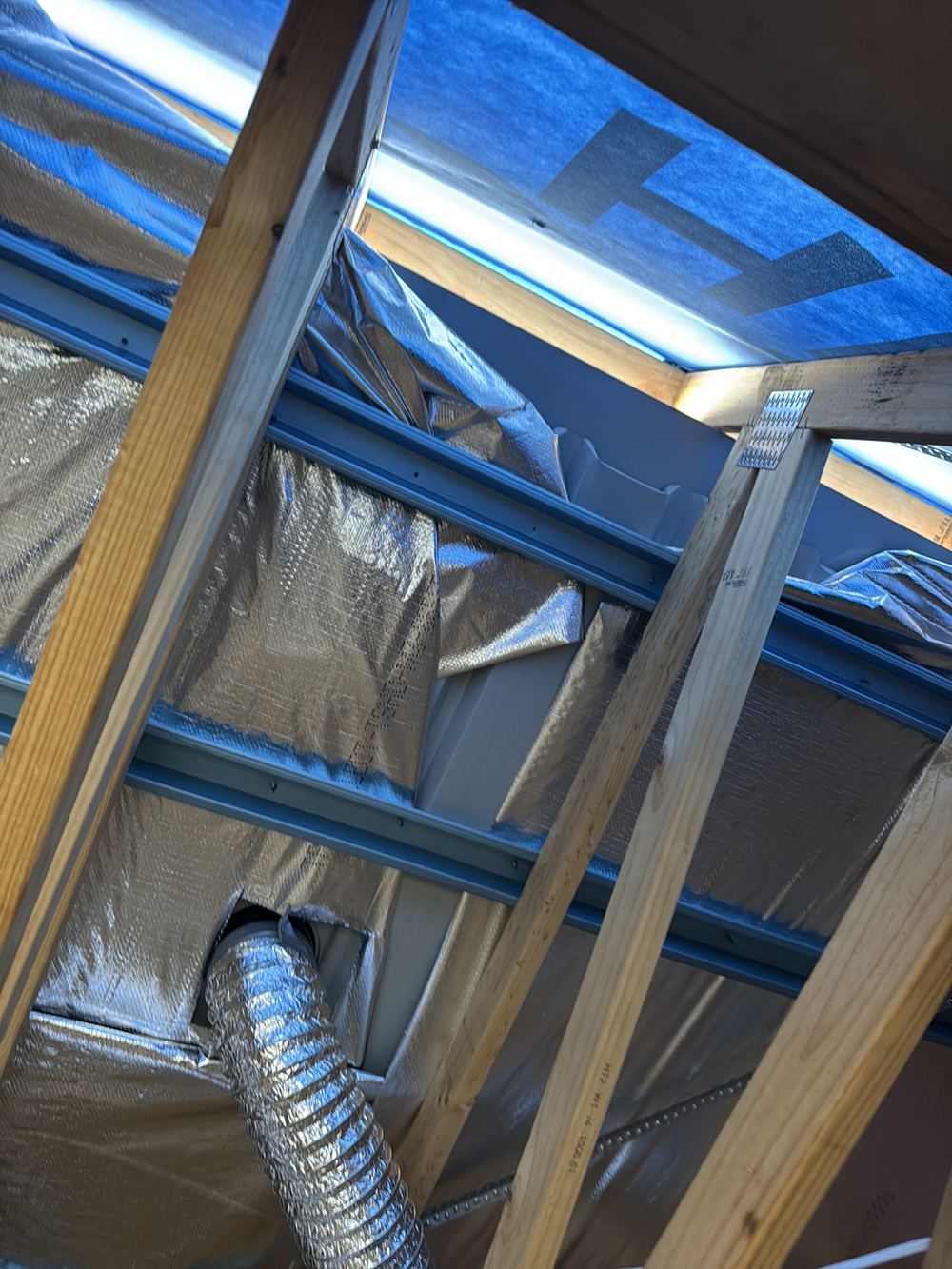 Roof sarking folded back on itself instead of laid flat and tensioned, found during a lock-up inspection in Officer