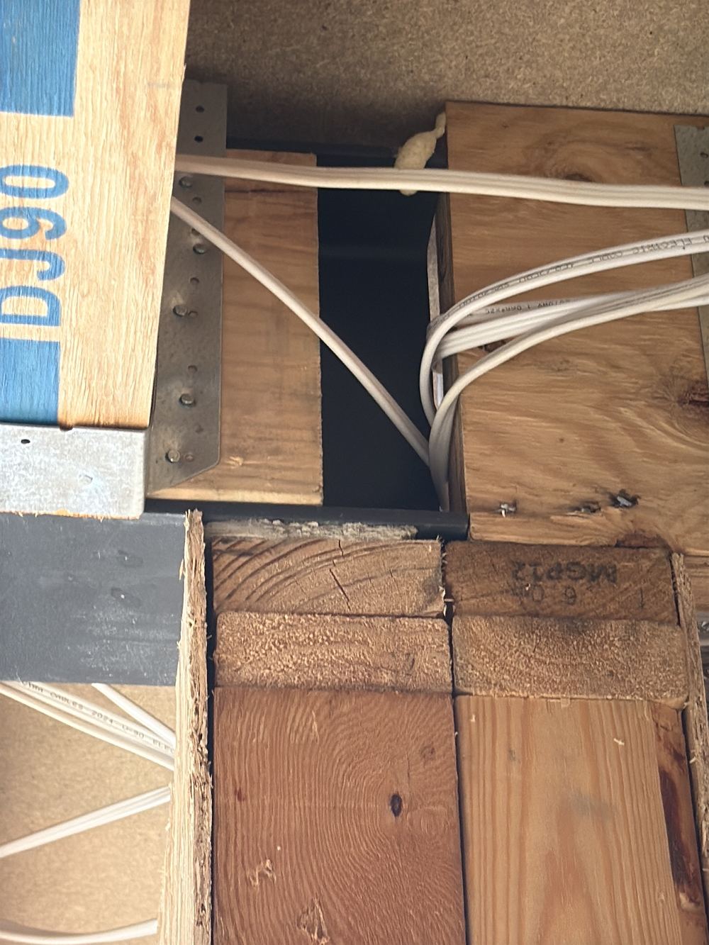 Fibre cement offcuts packed under a steel beam and trusses, not rated to carry load, found during a lock-up inspection in Officer