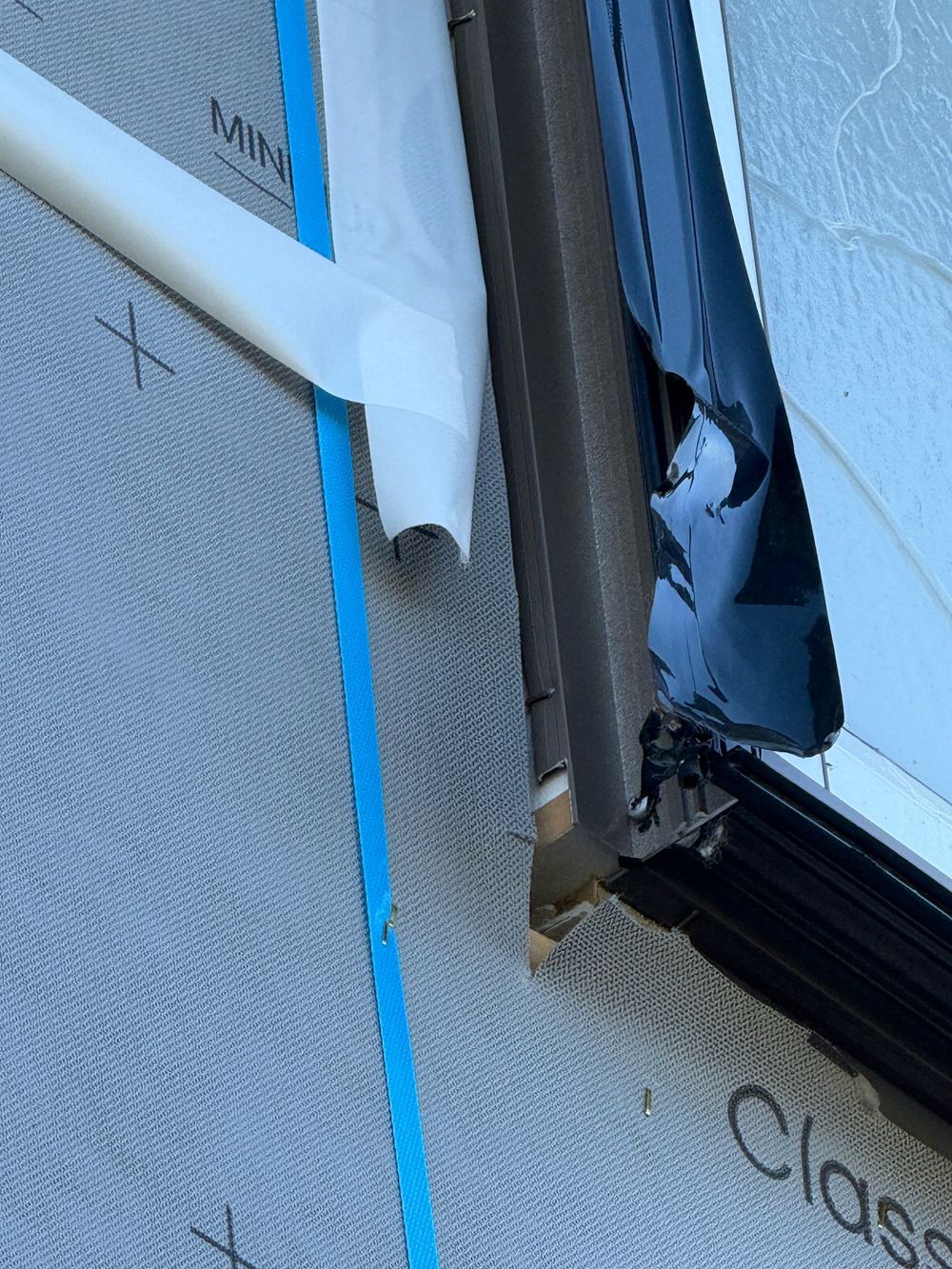 Window flashing tape lifting at jambs and sills, leaving gaps in the weather seal, Officer