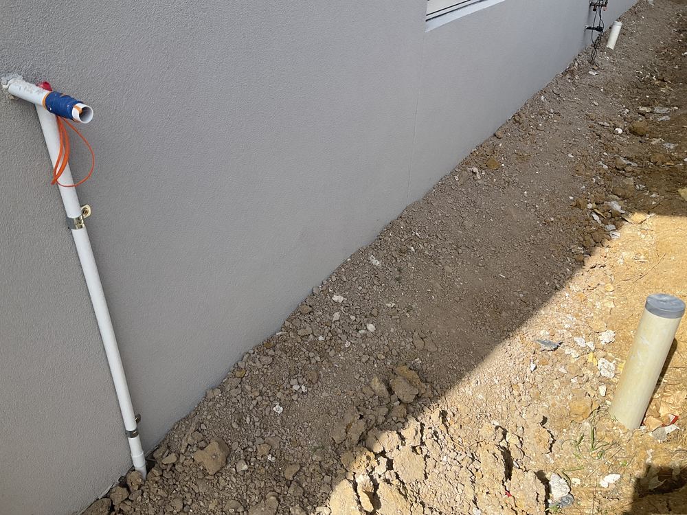 Cladding too close to the concrete, short of the 75mm gap that keeps damp out, found during a pre-handover inspection in Officer