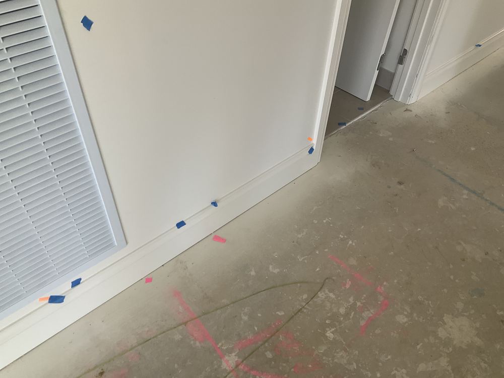Wall bowed by more than 5mm over 1.8m, outside the straightness tolerance, found during a pre-handover inspection in Officer