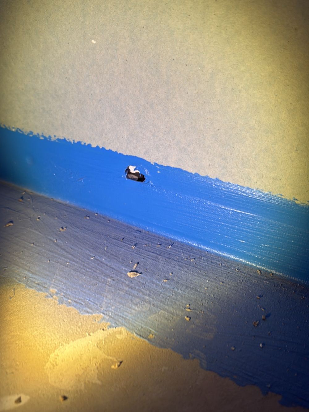 Membrane torn where a wide gap between frame and slab was never closed, found during a waterproofing inspection in Officer